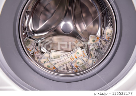 Pile of US dollar banknotes inside of washing machine Pile of US dollar banknotes inside of washing machine 135522177