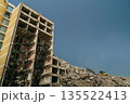 Excavator Clearing Rubble from Collapsed High-Rise building 135522413