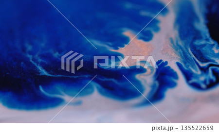 Ripple paint. Shiny fluid. Defocused blue orange color glitter marble texture chemical enamel water flowing on abstract background. 135522659