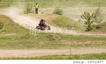 Motorcycle racer on the sports ATV during the competition 135522677