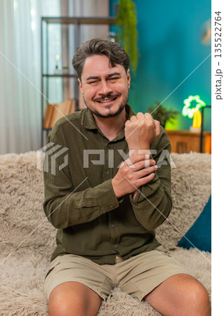 Middle-aged man massaging painful wrist injury strain discomfort ache chronic stress seeking relief Middle-aged man massaging painful wrist injury strain discomfort ache chronic stress seeking relief 135522764