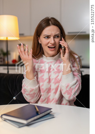 Adult woman shouts on smartphone at night rejects offer angry frown strong emotion stress upset mood Adult woman shouts on smartphone at night rejects offer angry frown strong emotion stress upset mood 135522775