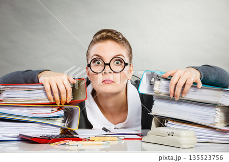 Obsessed female clerk at work. 135523756