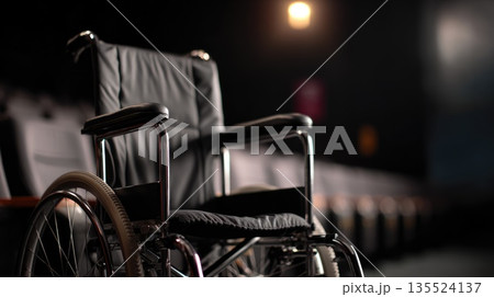 Empty Wheelchair in Dark Theater, Symbol of Accessibility and Social Inclusion Empty Wheelchair in Dark Theater, Symbol of Accessibility and Social Inclusion 135524137