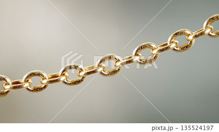 Detailed gold chain links arranged diagonally on soft neutral background Detailed gold chain links arranged diagonally on soft neutral background 135524197