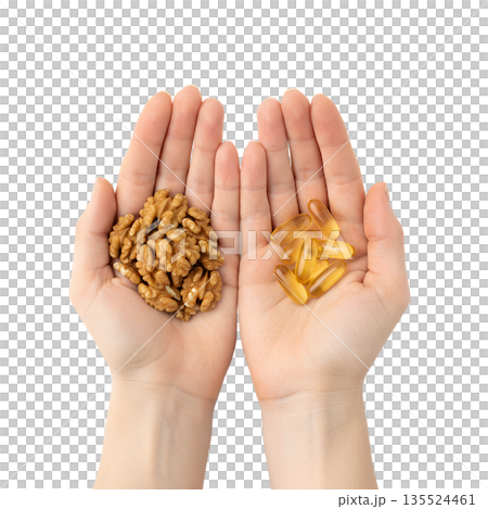 Nutrition comparison, handful of whole walnuts next to omega-3 supplement capsules, isolated. Represents natural ALA sources vs. supplements Nutrition comparison, handful of whole walnuts next to omega-3 supplement capsules, isolated. Represents natural ALA sources vs. supplements 135524461