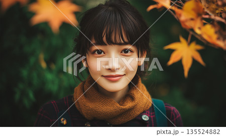 女子学生が深緑の秋背景でやさしく微笑む肖像 135524882