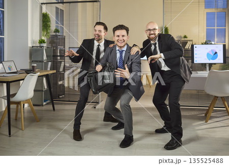 Happy businessmen celebrating victory as a team in modern office, success concept 135525488