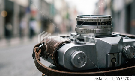 Tourists walk along busy streets in an Asian city while using cameras to capture local culture and everyday scenes. The atmosphere is lively and full of activity as they document their journey. 135525709