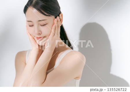 両手で頬を包み込む女性 135526722