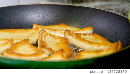 Rustic Pan Browns Pierogis To Perfection, Warm Kitchen Scene With Crispy Pierogis Frying In Butter Rustic Pan Browns Pierogis To Perfection, Warm Kitchen Scene With Crispy Pierogis Frying In Butter 135528570
