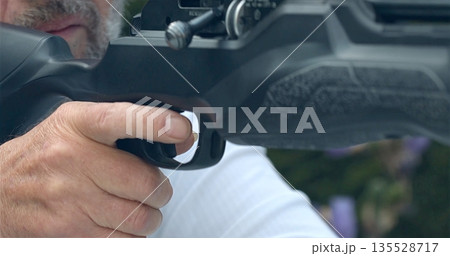 Man On Farm Handling Shotgun With Alertness, Caucasian Outdoors Focused On Preparing To Fire Weapon Man On Farm Handling Shotgun With Alertness, Caucasian Outdoors Focused On Preparing To Fire Weapon 135528717