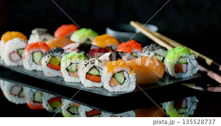 Assorted Sushi Platter With Colorful Varieties, Brightly Arranged Assortment Of Sushi With Accompaniments 135528737