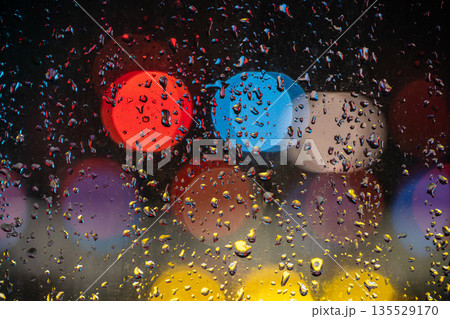 Raindrops on a window in Chengdu create colorful reflections at night Raindrops on a window in Chengdu create colorful reflections at night 135529170