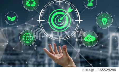 Digital illustration of a hand reaching towards target symbols representing sustainability, green technology, and environmental progress in a modern setting Gluon 135529290