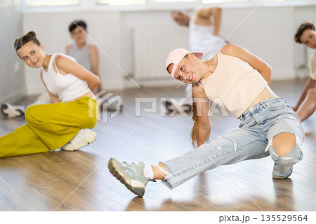 Teenage girl practicing hip-hop floor-works in training hall 135529564