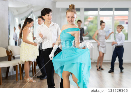 Girl in dress posing in dance studio Girl in dress posing in dance studio 135529566