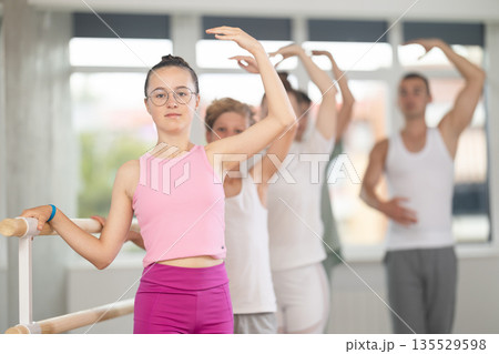 Girls and boys of choreographic lesson learn from experienced master of theatrical studio Girls and boys of choreographic lesson learn from experienced master of theatrical studio 135529598