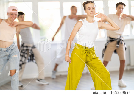 Teenage girl dancing jazz funk in group Teenage girl dancing jazz funk in group 135529655