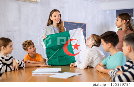 Teacher with flag of Algeria tells story of the emergence of state Teacher with flag of Algeria tells story of the emergence of state 135529784