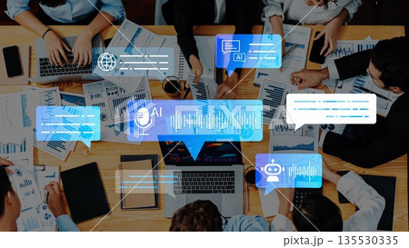 Team Collaboration with Artificial Intelligence Tools and Data Analysis on a Conference Table Surrounded by Laptops and Reports Gluon 135530335