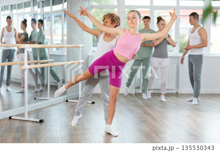 Ballet training for teenagers in a ballet studio under the guidance of choreographer Ballet training for teenagers in a ballet studio under the guidance of choreographer 135530343