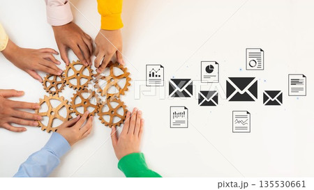Collaboration of Diverse Hands Over Wooden Gears and Email Icons Representing Communication, Teamwork, and Data Analysis in Modern Work Environments Gluon 135530661