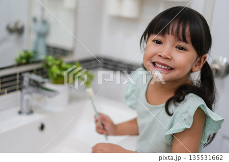 girl child brushing teeth in bathroom 135531662