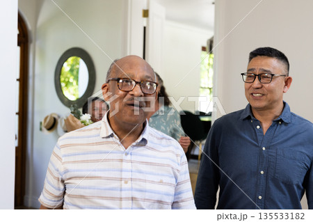 At home, senior men having conversation and sharing laughter during gathering 135533182