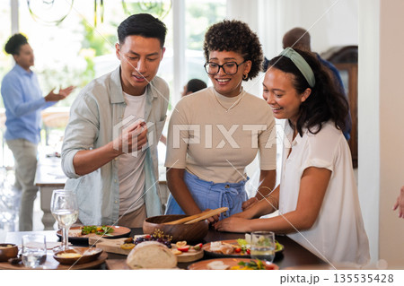 At wedding reception, friends chatting and smiling while enjoying delicious appetizers At wedding reception, friends chatting and smiling while enjoying delicious appetizers 135535428
