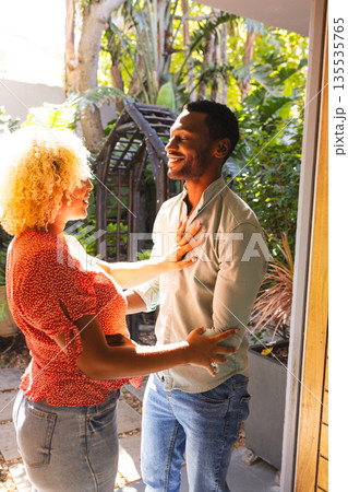 Friends enjoying warm conversation in sunny garden, sharing joyful smiles Friends enjoying warm conversation in sunny garden, sharing joyful smiles 135535765