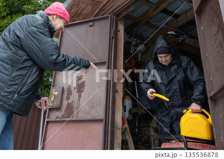 Two men starting generator in winter garage Two men starting generator in winter garage 135536878