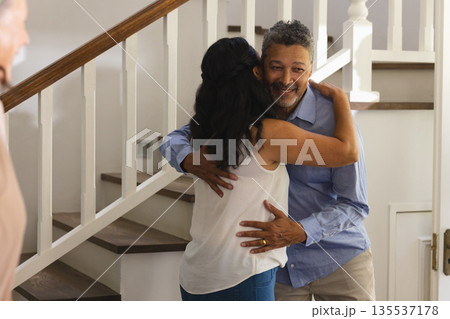 Embracing warmly, African American couple celebrating joyful moment on staircase 135537178