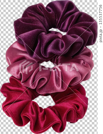 Three soft velvet scrunchies in a gradient of rich purple to pink shades 135537756