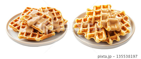 Waffles topped with creamy sauce served on white plate, isolated on white background, concept of sweet breakfast treat 135538197