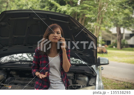 Women fix car call for help use phone calling insurance agent help fixing car problem breakdown. Woman calling mechanic car service technician support fix repair driving. Vehicle emergency problem Women fix car call for help use phone calling insurance agent help fixing car problem breakdown. Woman calling mechanic car service technician support fix repair driving. Vehicle emergency problem 135538293