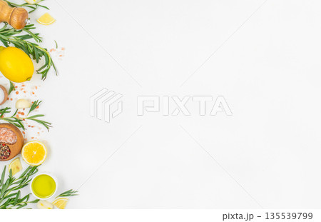 Fresh lemon rosemary and spices frame on white background with copy space Fresh lemon rosemary and spices frame on white background with copy space 135539799