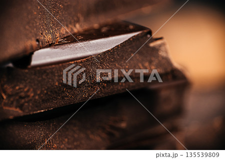 Dark chocolate pieces close up with rich texture and shallow depth of field 135539809