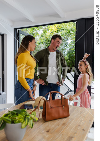 Family enjoying playful moment at home, smiling and laughing together Family enjoying playful moment at home, smiling and laughing together 135540839