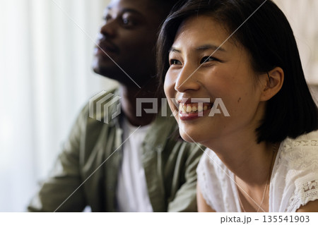 Smiling couple enjoying joyful moment together at wedding celebration indoors 135541903
