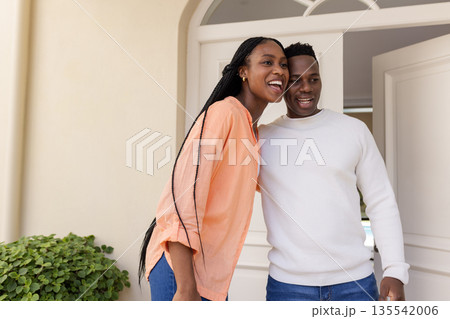Happy couple standing together at home, smiling and enjoying moment 135542006