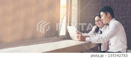 Banner Two businesspeople meeting work at office desk. Teamwork partners team with Business strategy chart graph, infographic financial report. Team partner planning excel stat report with copy space Banner Two businesspeople meeting work at office desk. Teamwork partners team with Business strategy chart graph, infographic financial report. Team partner planning excel stat report with copy space 135542783