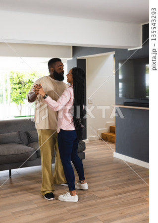 African American couple dancing together at home, enjoying joyful moment African American couple dancing together at home, enjoying joyful moment 135543293