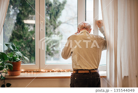 Elderly man waiting for family, calling them. Elderly man waiting for family, calling them. 135544049