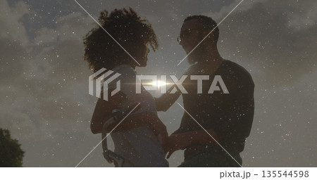 Standing pregnant woman in striped dress and man touching belly at sunset, with bicycle lens flare Standing pregnant woman in striped dress and man touching belly at sunset, with bicycle lens flare 135544598