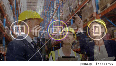 Managers wearing safety vest and hard hats checking boxes in warehouse aisle, with digital icons 135544795