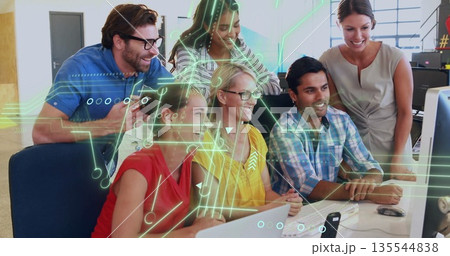 Team of six reviewing content on large monitor in office, in business casual attire 135544838