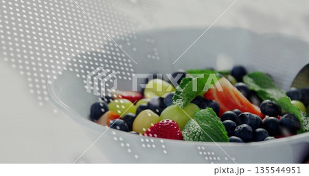 Displaying white ceramic bowl holding fresh fruit on kitchen counter, dotted map overlay Displaying white ceramic bowl holding fresh fruit on kitchen counter, dotted map overlay 135544951
