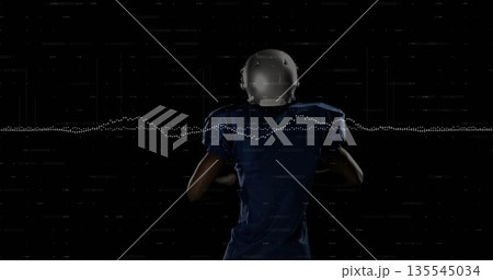 Holding football, player in blue jersey and helmet in studio with waveform and digital scan lines 135545034