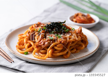 Stir fried Udon noodle with kimchi cabbage, pork, spring onion, sesame seed and seaweed on top 135545527